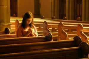 Woman-praying-at-church